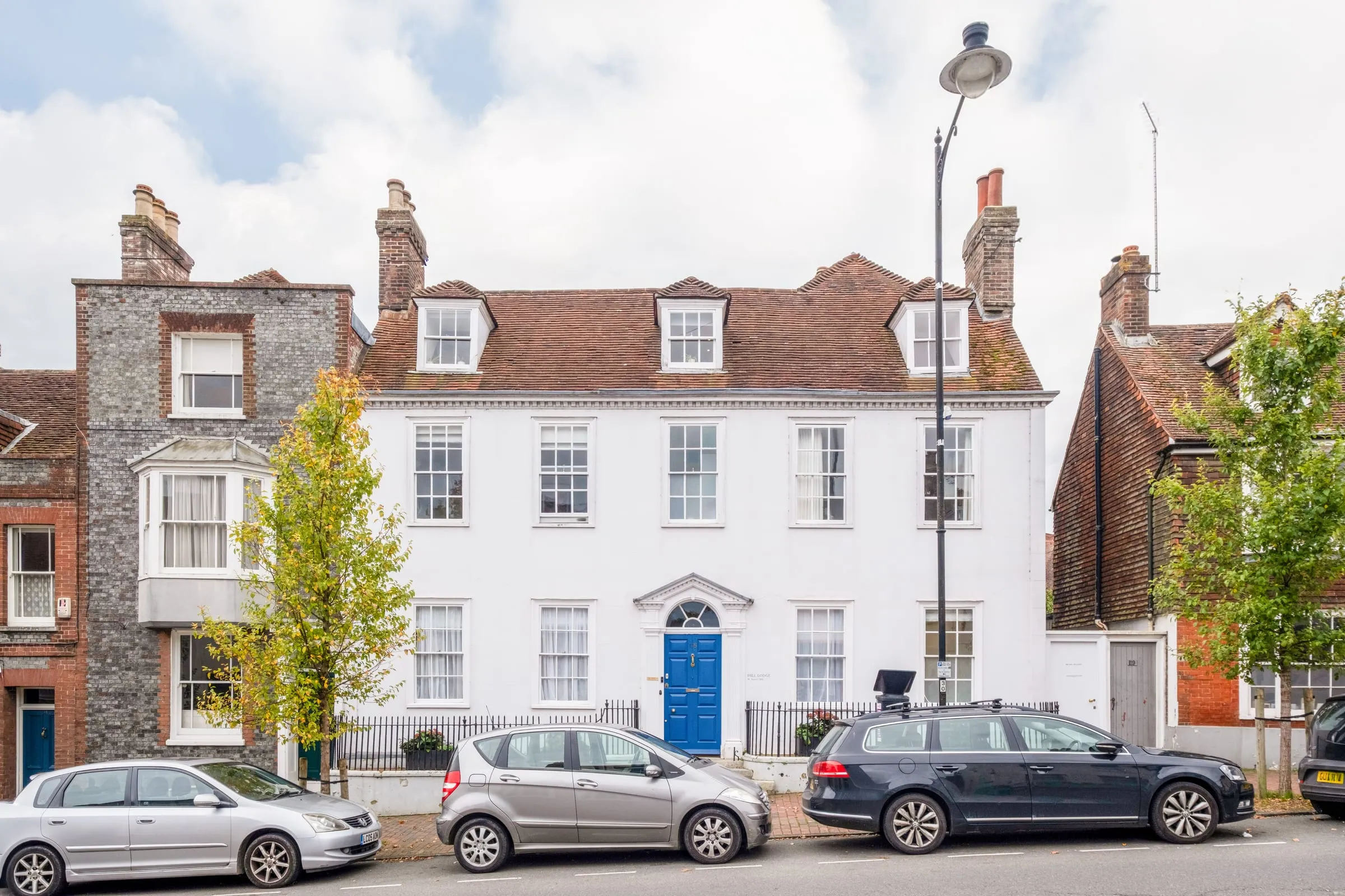 Hill Lodge, a white three-storey Georgian townhouse with a blue front door on Lewes High Street